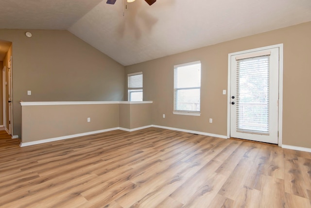 unfurnished room featuring light hardwood / wood-style floors, ceiling fan, and vaulted ceiling