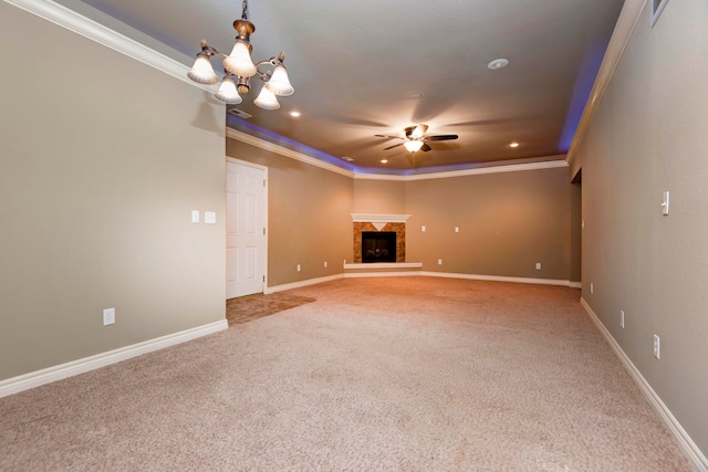 unfurnished living room with a tray ceiling, crown molding, carpet floors, and ceiling fan with notable chandelier