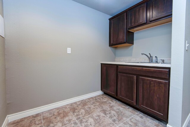 81 Clear Cove Dr, Reeds Spring, MO 65737 - bar with a sink, baseboards, and light tile patterned flooring