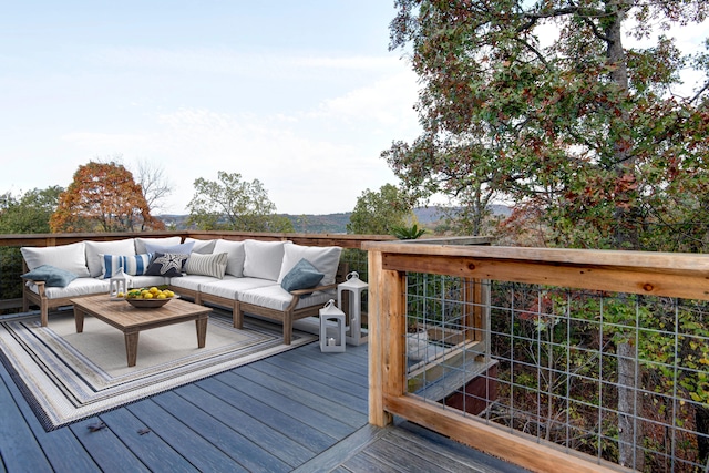 wooden terrace with an outdoor living space