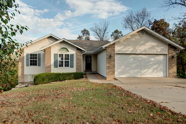 single story home featuring a front lawn and a garage