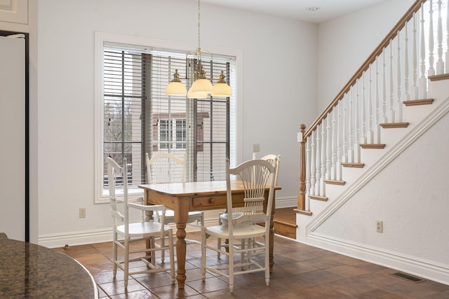 dining area featuring a notable chandelier and a wealth of natural light