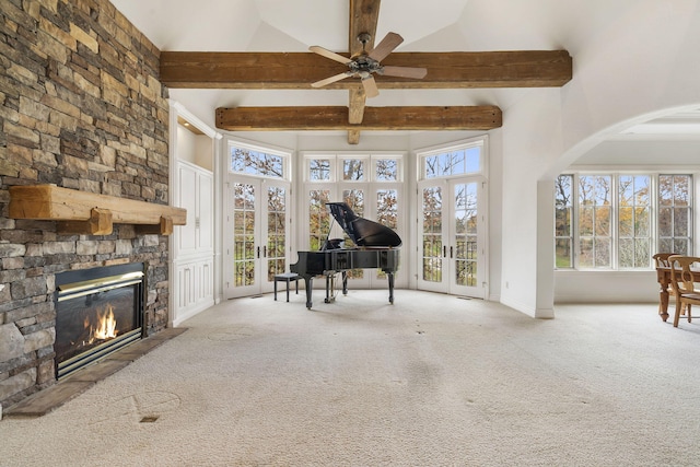 unfurnished living room with a fireplace, light colored carpet, and a towering ceiling