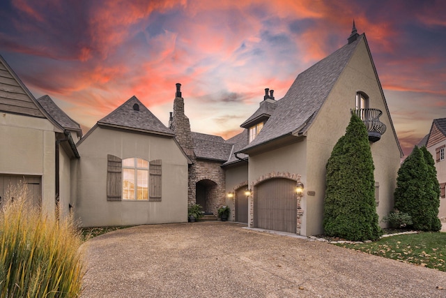 french country style house featuring a garage