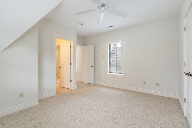 unfurnished bedroom featuring light carpet and ceiling fan