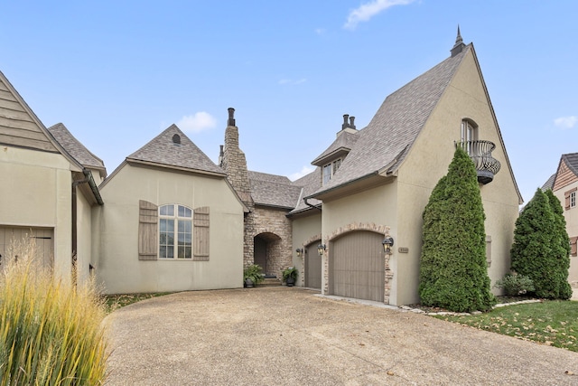 french country inspired facade featuring a garage