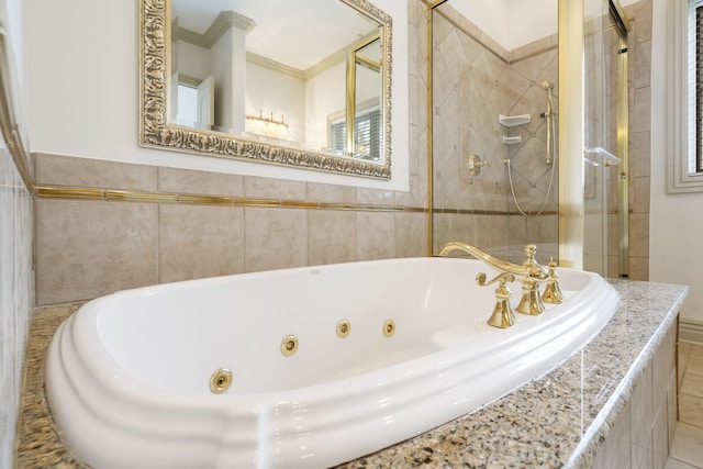 bathroom with ornamental molding and independent shower and bath