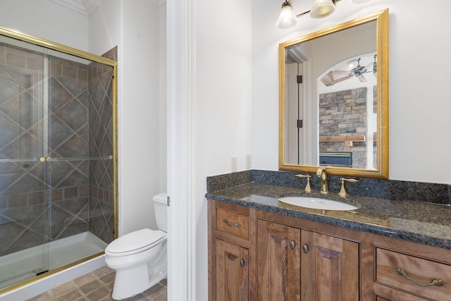 bathroom featuring vanity, crown molding, toilet, and an enclosed shower