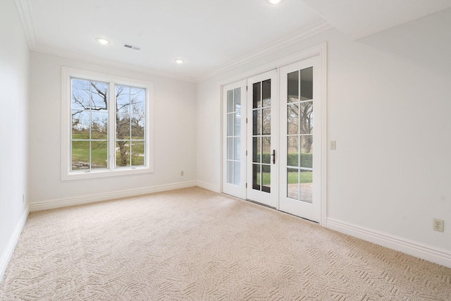 carpeted empty room with french doors and crown molding