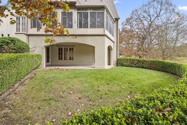 rear view of house featuring a yard and a patio area