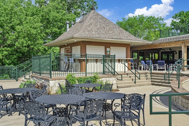 exterior space with ceiling fan