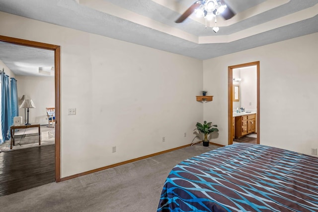 bedroom featuring carpet flooring, ensuite bathroom, ceiling fan, and sink