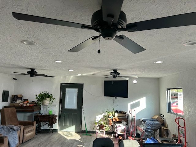 living room with a textured ceiling and wood-type flooring