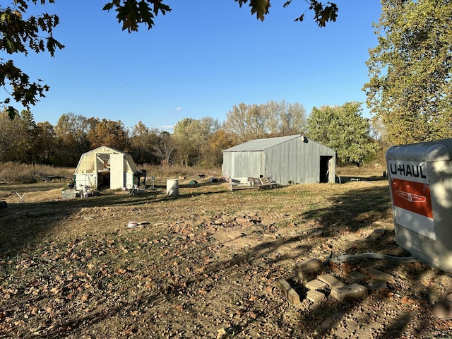 20600 Lawrence Unit 2200, Aurora, MO 65605 - view of yard featuring an outbuilding and view of wooded area