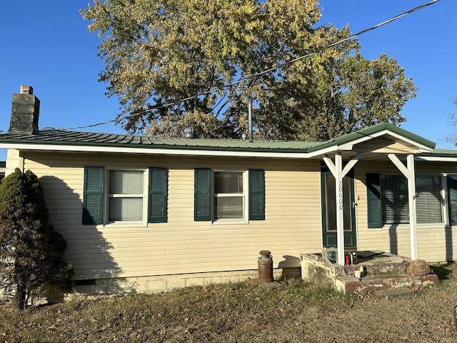 20600 Lawrence Unit 2200, Aurora, MO 65605 - view of home's exterior featuring a chimney and a metal roof