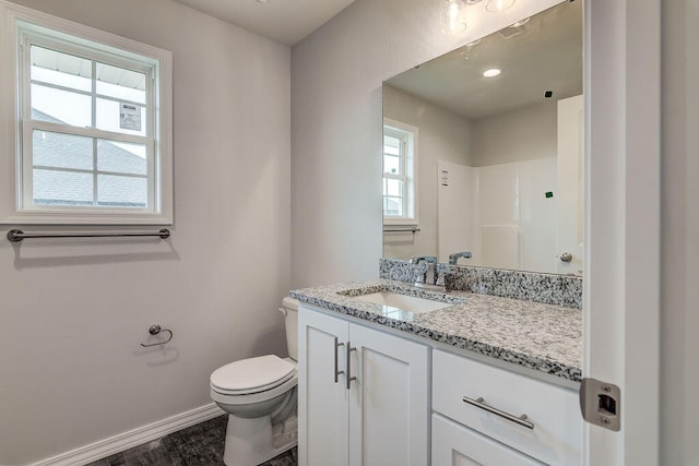 bathroom with vanity, toilet, walk in shower, and hardwood / wood-style floors