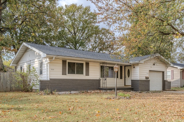 ranch-style house featuring a front lawn and a garage