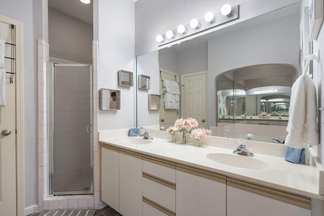 bathroom with vanity and a shower with shower door