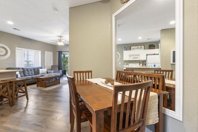 dining space with ceiling fan and dark hardwood / wood-style floors