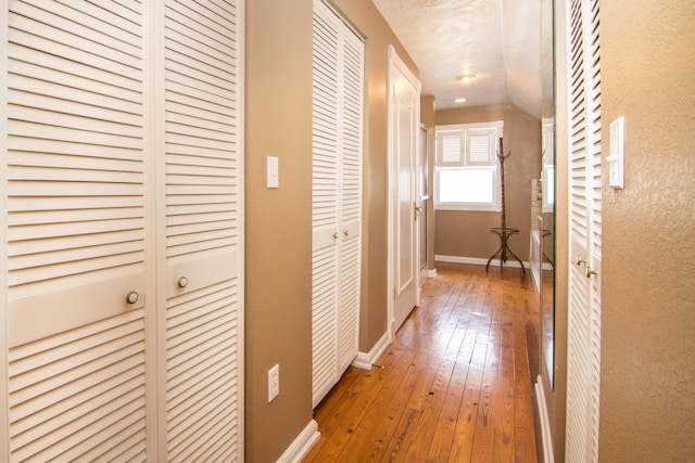 hallway with hardwood / wood-style flooring