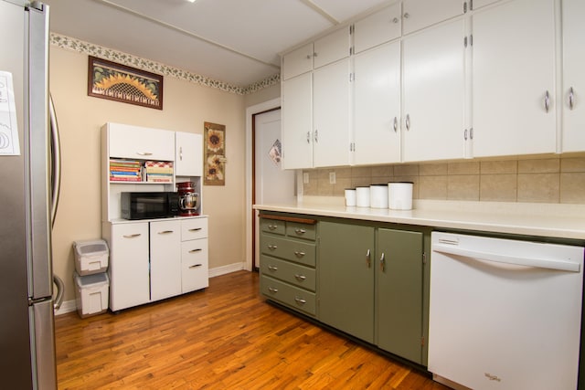 kitchen featuring dishwasher, backsplash, hardwood / wood-style floors, stainless steel fridge, and white cabinets