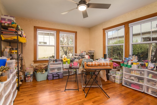 home office with light wood-type flooring and ceiling fan