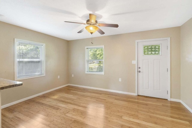 foyer with light wood-type flooring and ceiling fan