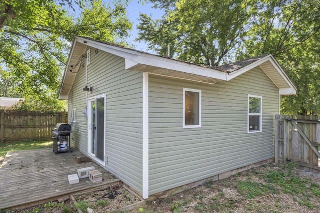 view of side of property with a wooden deck