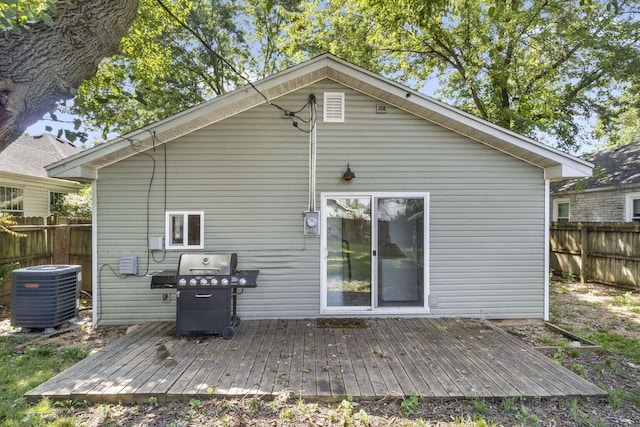 rear view of house with central AC and a deck