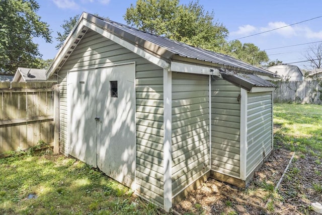 view of outdoor structure featuring a lawn