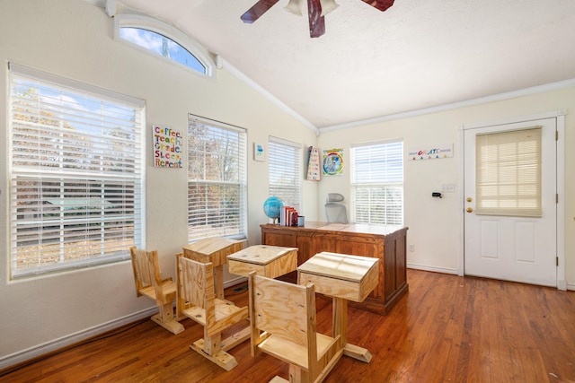 dining area featuring hardwood / wood-style flooring, vaulted ceiling, and a wealth of natural light