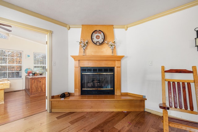 living room with ornamental molding, vaulted ceiling, wood-type flooring, and ceiling fan