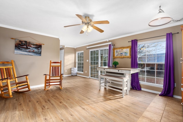 living area featuring ceiling fan, ornamental molding, and light hardwood / wood-style flooring