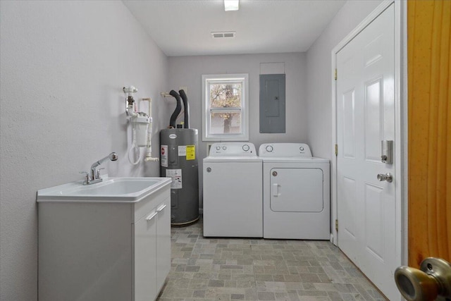 clothes washing area with sink, water heater, washer and clothes dryer, and electric panel