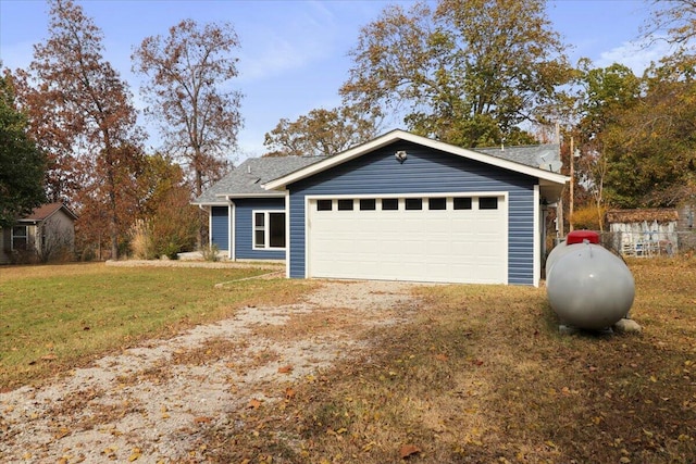 view of front of house with a front yard and a garage