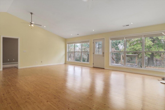 unfurnished living room featuring ceiling fan, vaulted ceiling, and light wood-type flooring