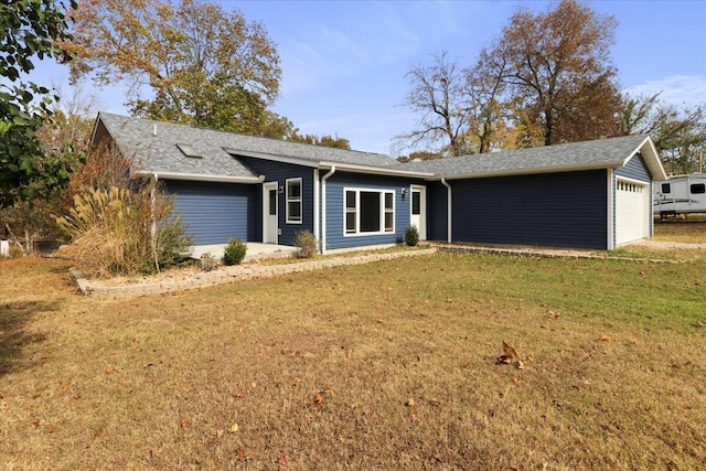 ranch-style home featuring a front lawn and a garage