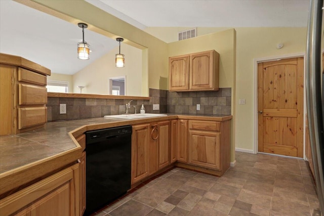 kitchen featuring sink, dishwasher, vaulted ceiling, decorative light fixtures, and decorative backsplash