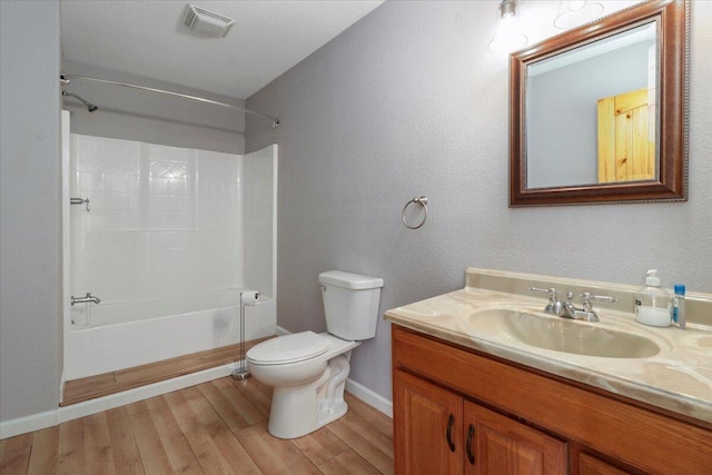 full bathroom with vanity, toilet, hardwood / wood-style flooring, and  shower combination