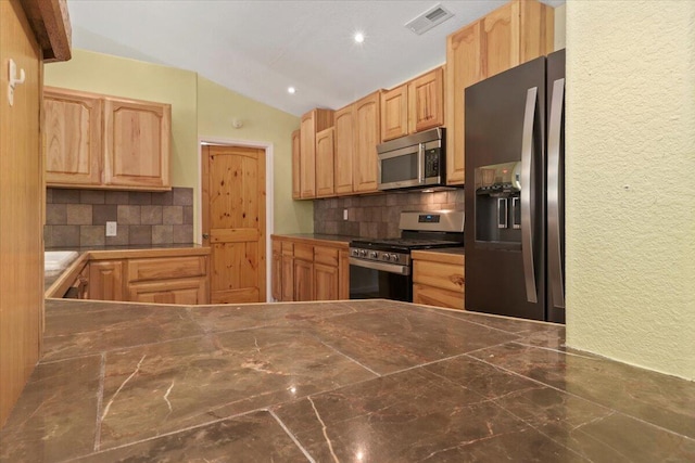 kitchen with backsplash, appliances with stainless steel finishes, lofted ceiling, and light brown cabinets