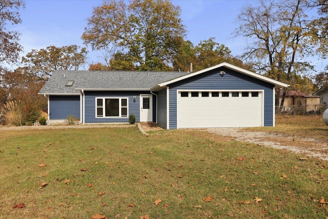 ranch-style house featuring a front yard and a garage