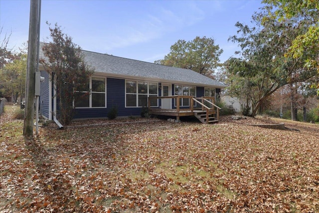 back of property featuring a wooden deck