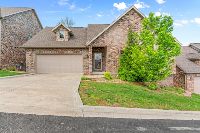 view of front property with a front lawn and central AC unit