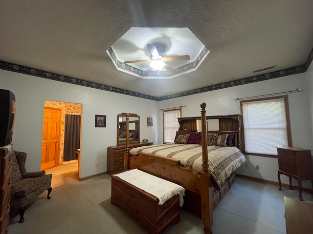 carpeted bedroom with multiple windows, a textured ceiling, and ceiling fan