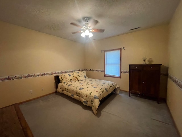 carpeted bedroom with a textured ceiling and ceiling fan