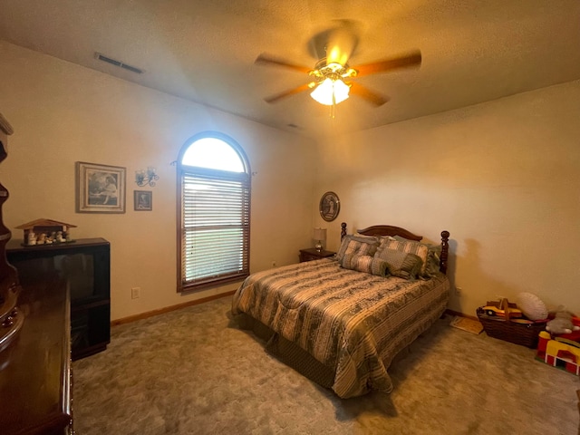 carpeted bedroom with a textured ceiling and ceiling fan