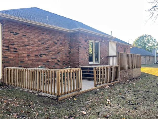 view of home's exterior with a yard and a deck