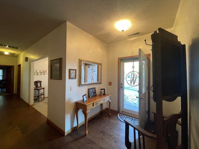 foyer featuring a textured ceiling and hardwood / wood-style flooring