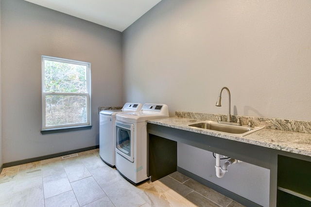 clothes washing area featuring sink and washer and dryer