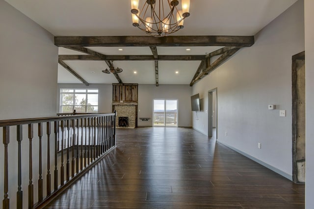 3133 Talking Rocks Rd, Reeds Spring, MO 65737 - unfurnished living room with a chandelier, beamed ceiling, dark wood finished floors, baseboards, and a fireplace